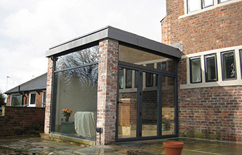 Modern extension to Listed building using aluminium, zinc and glass